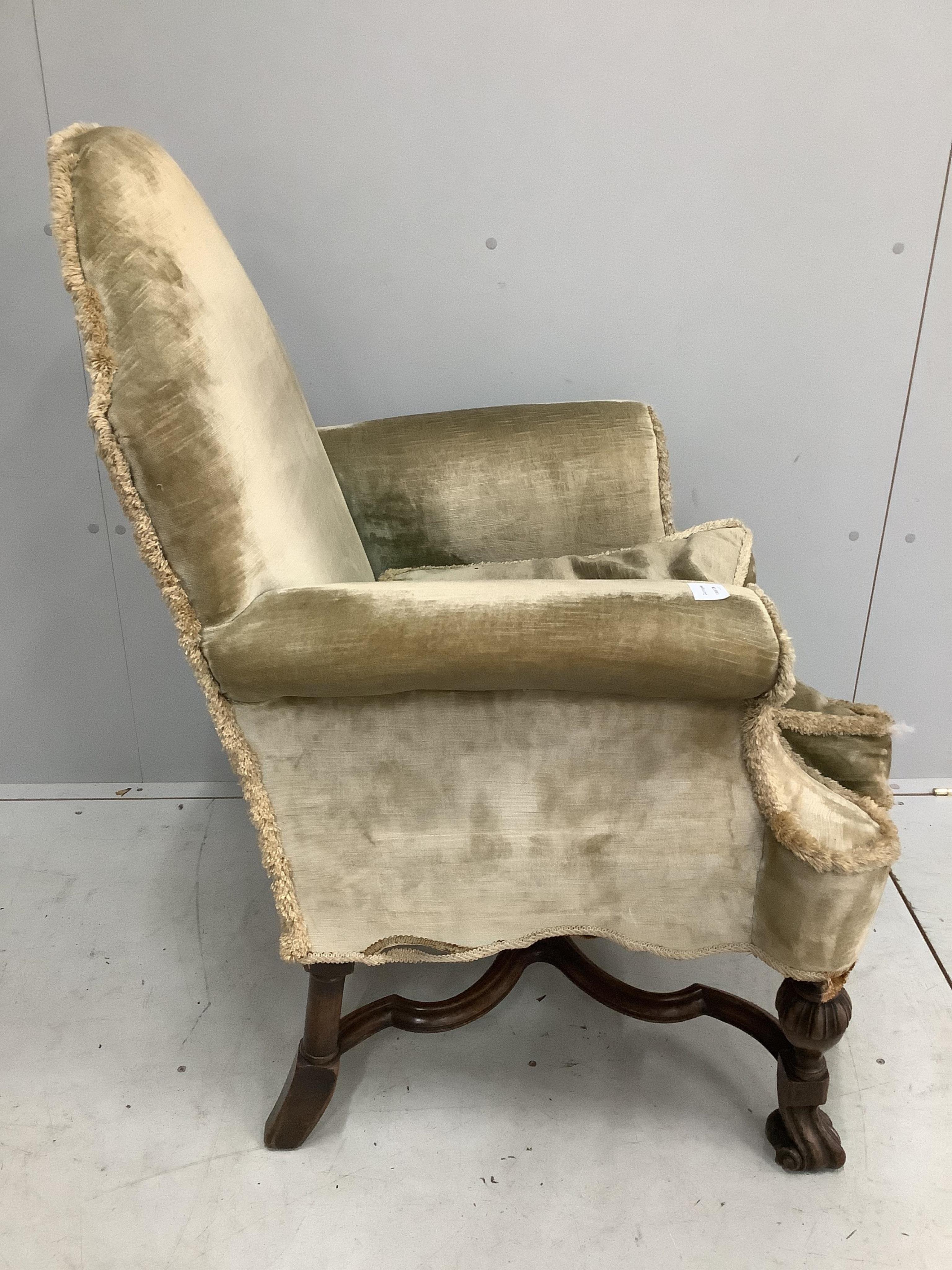 An early 20th century Jacobean Revival gold dralon upholstered armchair, width 78cm, depth 66cm, height 104cm. Condition - fair